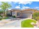 Charming single-story home with a desert landscape, tile roof, and two-car garage at 9475 N 115Th Pl, Scottsdale, AZ 85259