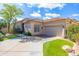 Stunning single-story home featuring a tile roof, desert landscaping, and a paved driveway at 9475 N 115Th Pl, Scottsdale, AZ 85259