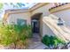 Inviting front entrance with glass-paneled door, side window, and lush greenery at 9475 N 115Th Pl, Scottsdale, AZ 85259