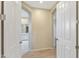 Hallway features an arched ceiling leading to bathroom with white painted doors and wood floor at 9475 N 115Th Pl, Scottsdale, AZ 85259