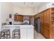 Spacious kitchen features stainless steel appliances, an island with seating, and wooden cabinetry at 9475 N 115Th Pl, Scottsdale, AZ 85259