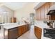 This bright kitchen features wooden cabinets, stainless steel appliances, and white countertops with a sink at 9475 N 115Th Pl, Scottsdale, AZ 85259