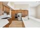 Spacious kitchen featuring custom wood cabinets, stainless steel appliances, and breakfast bar at 9475 N 115Th Pl, Scottsdale, AZ 85259