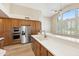 Gourmet kitchen with stainless steel appliances, breakfast bar, and light filled windows at 9475 N 115Th Pl, Scottsdale, AZ 85259