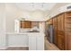 Open kitchen featuring a breakfast bar, custom wood cabinets and stainless steel appliances at 9475 N 115Th Pl, Scottsdale, AZ 85259