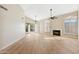 Spacious living room featuring a fireplace, ceiling fans, and wood flooring at 9475 N 115Th Pl, Scottsdale, AZ 85259