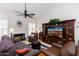 Comfortable living room featuring hardwood floors, a cozy fireplace, and stylish furniture at 9475 N 115Th Pl, Scottsdale, AZ 85259