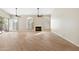 Open living room with hardwood floors, fireplace, plantation shutters, and sliding door at 9475 N 115Th Pl, Scottsdale, AZ 85259