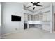 Bright home office with custom built-ins, desk space, and beverage cooler at 9475 N 115Th Pl, Scottsdale, AZ 85259