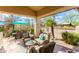 Inviting covered patio with comfortable seating, dining area, and lush landscaping at 9475 N 115Th Pl, Scottsdale, AZ 85259