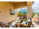 Charming covered patio with outdoor seating, dining area, and a mounted flat-screen TV at 9475 N 115Th Pl, Scottsdale, AZ 85259