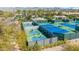 Community pickleball and tennis courts surrounded by mature trees and lush landscaping, offering a great recreational space at 9475 N 115Th Pl, Scottsdale, AZ 85259