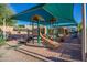 Fun playground featuring slides and climbing structures, sheltered by a bright shade canopy, perfect for Gathering enjoyment at 9475 N 115Th Pl, Scottsdale, AZ 85259