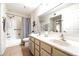 Bathroom with double sinks, large mirror, bathtub with shower, and ample cabinet space at 9736 N 95Th St # 126, Scottsdale, AZ 85258