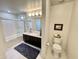 Clean bathroom featuring a double sink vanity, shower-tub combo, and a toilet with a coordinated aesthetic at 10249 N 12Th Pl # 2, Phoenix, AZ 85020