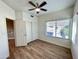 Bedroom features wood-look floors, closet with sliding doors, and large window at 10249 N 12Th Pl # 2, Phoenix, AZ 85020