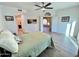 Bright bedroom featuring wood-look floors, a ceiling fan, and multiple doorways for easy access at 10249 N 12Th Pl # 2, Phoenix, AZ 85020