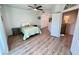 Bedroom with wood-look floors and a view of the loft area and staircase at 10249 N 12Th Pl # 2, Phoenix, AZ 85020