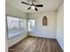 Cozy bedroom featuring wood-look floors, a ceiling fan, and a sunny window at 10249 N 12Th Pl # 2, Phoenix, AZ 85020