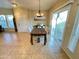 Inviting dining area with modern light fixture and access to patio via sliding glass door at 10249 N 12Th Pl # 2, Phoenix, AZ 85020