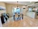 Cozy dining area with modern chandelier, view to the patio, and adjacent to kitchen with breakfast bar at 10249 N 12Th Pl # 2, Phoenix, AZ 85020