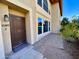 Welcoming front entrance to a two-story townhome featuring brick pavers and desert landscaping at 10249 N 12Th Pl # 2, Phoenix, AZ 85020