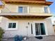 Exterior view of the home featuring a balcony, sliding glass doors, and a well-maintained patio area at 10249 N 12Th Pl # 2, Phoenix, AZ 85020