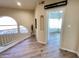 Upstairs hallway with wood flooring, access to bedroom, and decorative lighting at 10249 N 12Th Pl # 2, Phoenix, AZ 85020