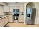 Bright kitchen featuring stainless steel appliances, granite countertops, and plentiful cabinet space at 10249 N 12Th Pl # 2, Phoenix, AZ 85020