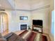 Cozy living room featuring a fireplace, tiled floor, and views of the mezzanine above at 10249 N 12Th Pl # 2, Phoenix, AZ 85020