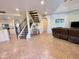 Open-concept living area features tile flooring, staircase, and seamless flow to the kitchen at 10249 N 12Th Pl # 2, Phoenix, AZ 85020