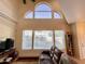 Living room featuring large windows, vaulted ceilings, and natural lighting at 10249 N 12Th Pl # 2, Phoenix, AZ 85020