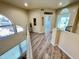 Open loft area with wood floors, arched windows, and a view of the stairway at 10249 N 12Th Pl # 2, Phoenix, AZ 85020