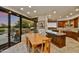 Open dining area with a large table, tile flooring, and seamless access to both the kitchen and outdoor spaces at 10567 E Fernwood Ln, Scottsdale, AZ 85262