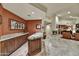 Open-concept living room with fireplace, tile floors, custom cabinets and granite countertops at 10567 E Fernwood Ln, Scottsdale, AZ 85262