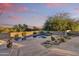 Backyard pool and jacuzzi surrounded by desert landscaping and a concrete patio with ample lounging space at 10567 E Fernwood Ln, Scottsdale, AZ 85262