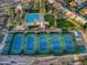 An aerial view showcases the community's sparkling pool, tennis courts, and well-manicured grounds at 11216 E Appaloosa Pl, Scottsdale, AZ 85259