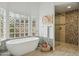 Modern bathroom with a soaking tub, stylish fixtures, and tiled shower at 11216 E Appaloosa Pl, Scottsdale, AZ 85259