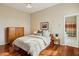 Cozy bedroom featuring hardwood floors and a view into the bathroom at 11216 E Appaloosa Pl, Scottsdale, AZ 85259