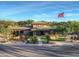 Community center featuring water feature, mature landscaping and palm trees, and an American flag waving in the breeze at 11216 E Appaloosa Pl, Scottsdale, AZ 85259