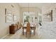 Dining room with chandelier, modern art, and view of the pool and backyard at 11216 E Appaloosa Pl, Scottsdale, AZ 85259