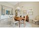 Light filled dining room with a wood table, chandelier, and modern artwork at 11216 E Appaloosa Pl, Scottsdale, AZ 85259