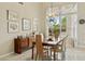 Bright dining room with wood table set for six, chandelier, and view of the pool at 11216 E Appaloosa Pl, Scottsdale, AZ 85259