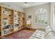 Bright living room featuring hardwood floors, large bookshelves, and comfortable seating at 11216 E Appaloosa Pl, Scottsdale, AZ 85259