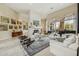 Open concept living room with high ceilings, tile floors, and a white stone fireplace at 11216 E Appaloosa Pl, Scottsdale, AZ 85259