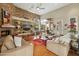 Bright living area with a stone accent wall, built-in shelves, and an open floor plan with view to the yard at 11216 E Appaloosa Pl, Scottsdale, AZ 85259