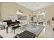 Spacious living room featuring a black piano, modern decor, and an arched entry at 11216 E Appaloosa Pl, Scottsdale, AZ 85259