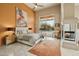 A stylish main bedroom featuring a fireplace, ceiling fan, and a view of the pool at 11216 E Appaloosa Pl, Scottsdale, AZ 85259