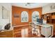 Home office with arched windows, modern desk, and built-in shelves, offering a bright and functional workspace at 11216 E Appaloosa Pl, Scottsdale, AZ 85259