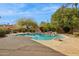 Lush backyard oasis featuring a freeform pool, rock accents, and mature landscaping for privacy at 11216 E Appaloosa Pl, Scottsdale, AZ 85259